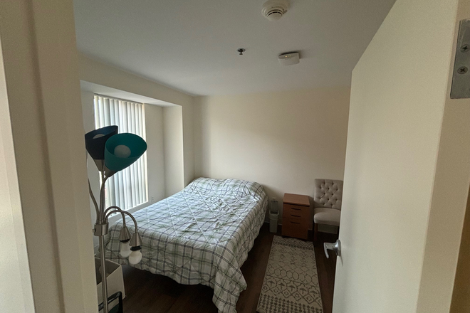 Bedroom with queen bed and closet - One Western Ave - 1 bedroom apartment - middle of beautiful HBS campus