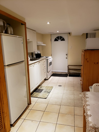 Kitchen & entrance door - 1 Furnished Bsmt. near Pape Subway. Wi-Fi & Laundry. Apartments