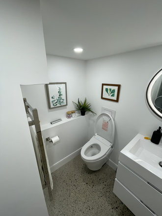 Bathroom - heated concrete floors and a toilet with bidet - Cozy One Bedroom Basement Apt
