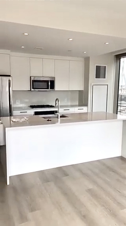 Open kitchen with island - Bright Corner 1BR at Alcott Boston / West End / June 15th Apartments
