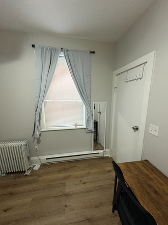 Window looking into street with curtains and shutters - Housing near campus