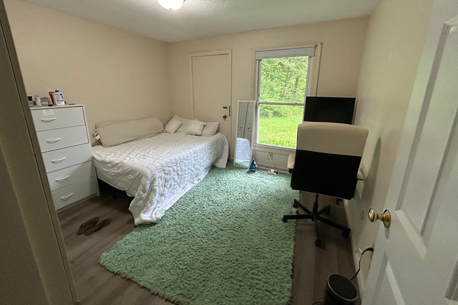 This will your bedroom. It has a window that faces the woods. The current occupant likes to leave it uncovered for natural light. - Riverside Apartments