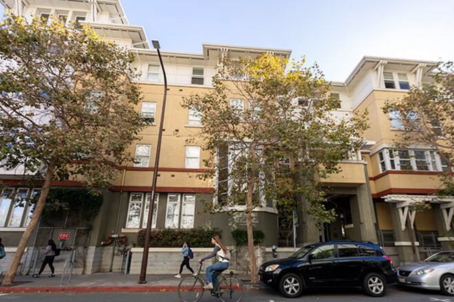 Exterior of the Ida L. Jackson Apartments on tree-lined College Avenue, just a block from campus. - Ida L. Jackson Graduate Student Apartments