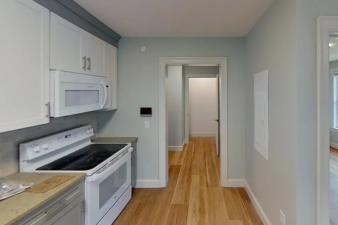 Kitchen (with view of front hall) - Center East Commons Apartments