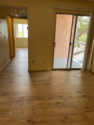 Living room and hall with new plank flooring - Affordable Quiet Complex Near the University of Arizona Apartments