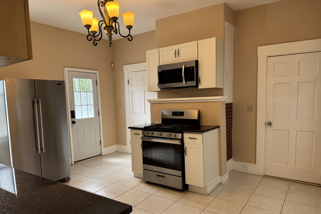 kitchen with tile floors and updated appliances - 6 bed/ 4 bath in Prime Location on Foster Street!! Available 2027 Duplex