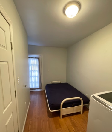 Second bedroom/laundry room - For His Glory Apartments