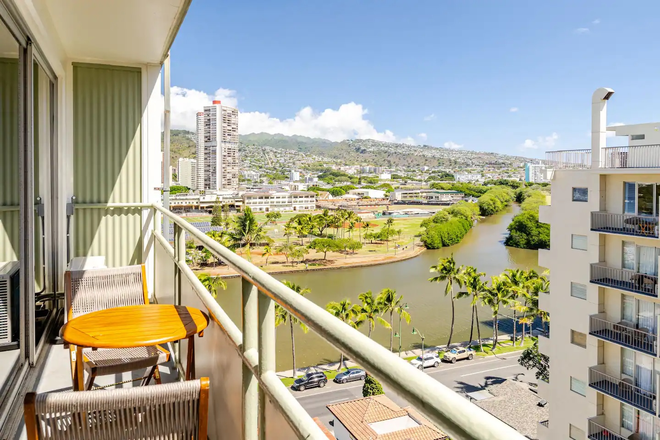 Lanai with canal and mountain views — Ala Wai and the Ko'olau Range from the 11th floor. - Renovated Waikiki Studio — Fully Furnished, All Utilities | June 1 Condo