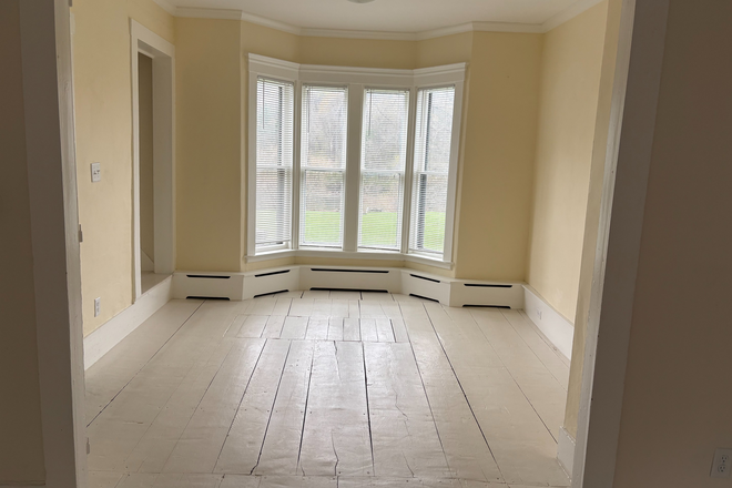 bay window facing the river in room adjacent to kitchen - Beautiful spot on the White River and a convenient 2 mile drive (or walk!) to VLS. Apartments