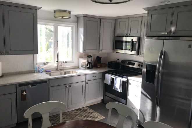 Kitchen fully stocked, table and chairs - Eastward Look Great House