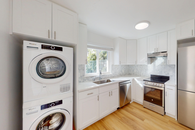 Kitchen with cabinets, stacked washer-dryer, stainless appliances, wood floor - 1771 Highland Place