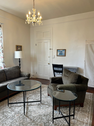 Living room seating and desk - Furnished Garden District 1 Bedroom apartment