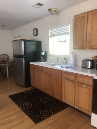 Kitchen with full sized refrigerator - Spacious Apartment in Old Mt. Pleasant, Utilities, Internet and Cable TV Included