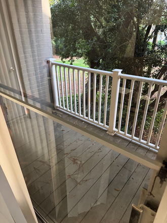 Back patio. Storage unit is outside and is completely empty and is available for renter to use. - Legacy at Druid Hills Apartments