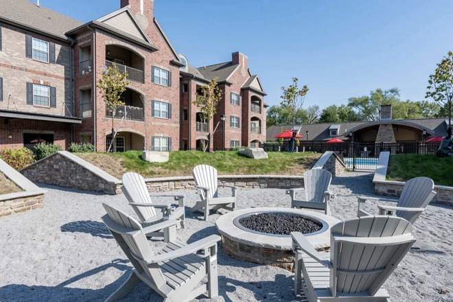 Outdoor fire pit and sitting area - Miami Preserve Spring 2027 Apartments