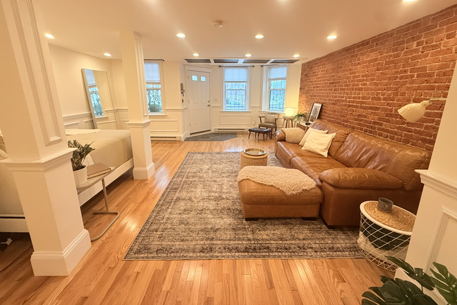 living area - sofa, great natural light, huge windows, private entrance - FURNISHED STUDIO — 689 SQ FT — LONGWOOD / BROOKLINE BORDER Condo