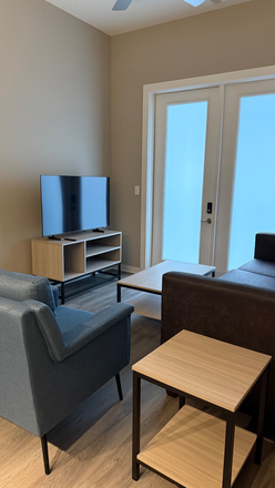 Living room/ Outdoor Access to Patio - The Standard at Four Corners, 2 minutes from campus, 1/3 bedrooms available, lease from 08/2026 Apartments