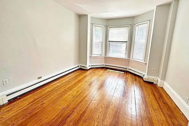 Bedroom - Spacious Primary Bedroom in 2BR East Boston Apt – 10 min to T, balcony, garden access