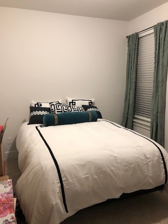 Bedroom with queen bed, walk-in closet, desk, chair and smart TV on a private wing of the home - New Contemporary Home in Paloma Creek-Little Elm, TX