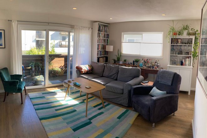 Living room and balcony - Sunny Top-Floor 2BR with Balcony and Yard in Dimond (Temporary 11-mo. rental 7/26-5/27)