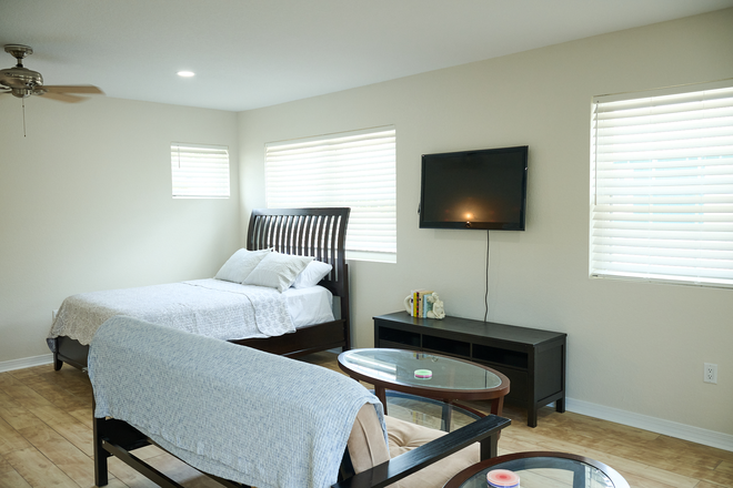 Living space and queen bed - Furnished Studio Apartment Near UCF Downtown