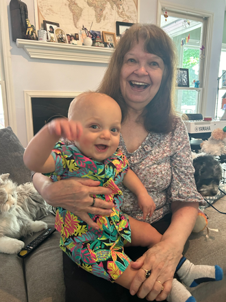 My grandbaby and I in living room - Lg Mod MBR w Priv Bath in Beautiful Neighborhood, 20 mins to campus. 1 other person in home.