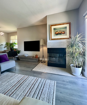 Living Room - 65" TV and wood burning fireplace - Everyone Loves living in Marina Bay - Luxury Furnished two bedroom, two bath condo near the water