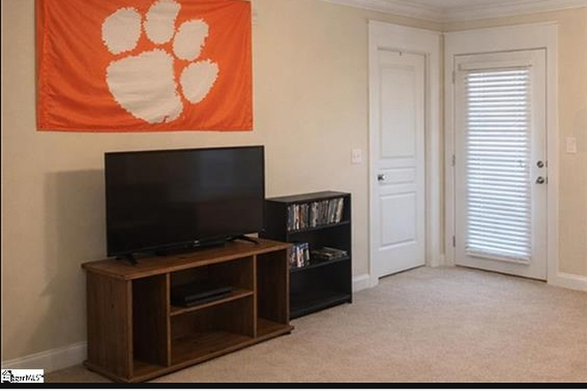 Right side of the den. (Door to left opens into the 2nd bedroom. Door to right goes out onto the covered patio. - Woodlands of Clemson Condo