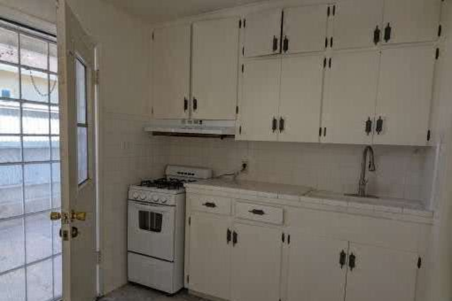 full kitchen and back doorway to small private back patio. - two bedroom, one bath, 1100 SQ Feet, walk to campus
