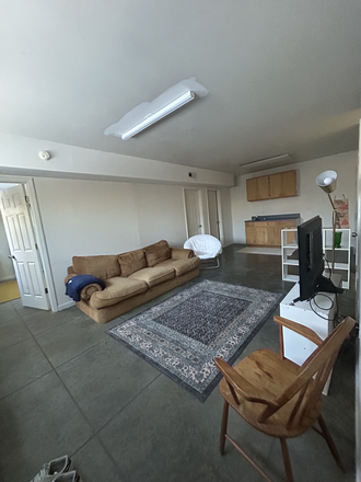 Living Room - Private Room and Bathroom with PARKING SPOT, 10 minute walk from campus Apartments