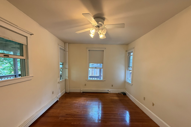 Bedroom with ceiling fan - Spacious one bedroom with parking/washer dryer in unit Apartments