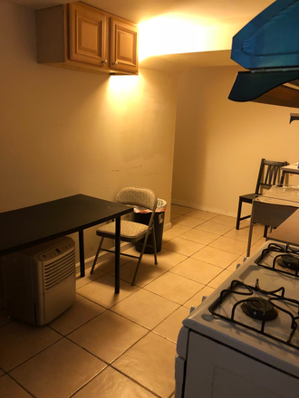 Entering Kitchen from front door - TWO rooms OPENED in a 3BD/1BA/Kitchen basement level unit for SPRING 2026 Apartments