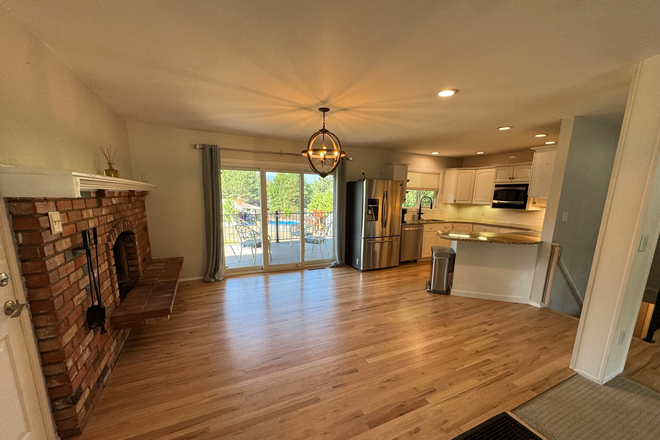 Dining area and kitchen with fireplace - Beautiful, spacious home w/garage & yard close to UCCS in quiet neighborhood