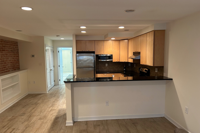 View of the living room/library/kitchen area - Bloomingdale Basement Apartment. D30 Bus runs on North Capitol to CU
