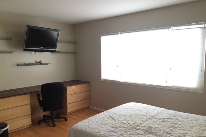 Bedroom desk and window with Bay View - Furnished Room + Private Bath + Walk-in Closet in LGBTQ-Friendly Home with Stunning Views