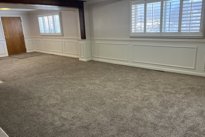 Living space - A lot of natural light streams through these Westside windows, especially in evening - 1500 sq ft walkout bsmt apt at base of Millcreek canyon, view of Mt Olympus