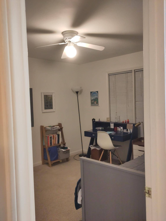 View of first floor bedroom, wall to the right and opposite to entrance. Window faces back patio (furnishing will be removed). - Room in Carrboro townhouse, walkable to downtown, bikable to campus