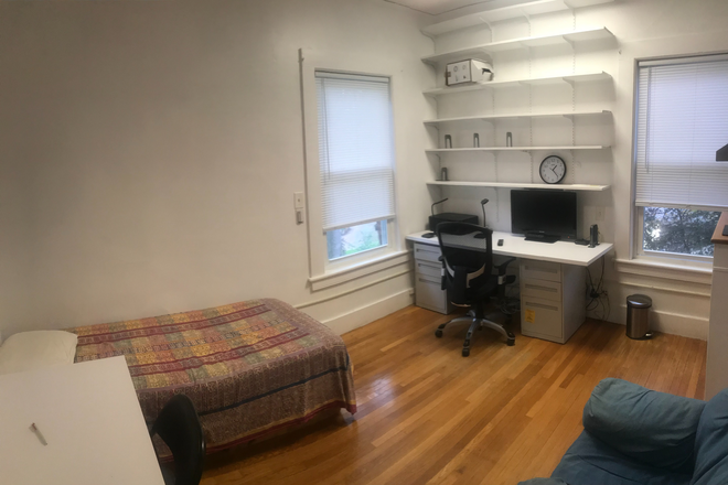 Desk with bed & chair. Note two windowes on on each side of desk - Furn. Studio w utility, AC. internet, wash, dryer, bath, kitch refrig. ceramic cooktop. Porter Sq.