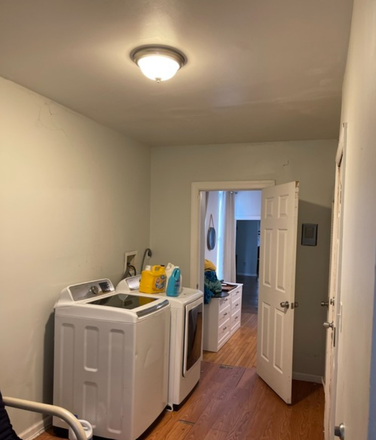Second bedroom/laundry room - For His Glory Apartments