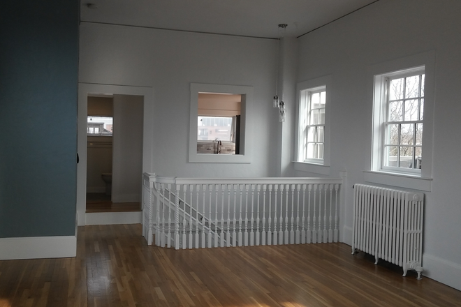 entry to 1st full bath and kitchen - Unique PH loft in brick, elevator bldg near Harvard Sq. Upgraded. 2 full baths! Huge deck!