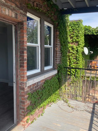 View of the balcony, looking into the available bedroom - One room in 3BR/1B - on the Orange line - under $1000/month! - 12 month lease