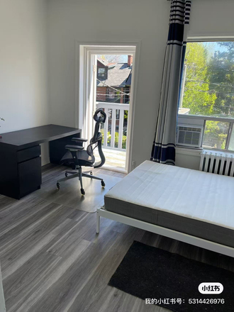 desk with a door to an outside patio - a furnished bedroom with laundry and kitchen