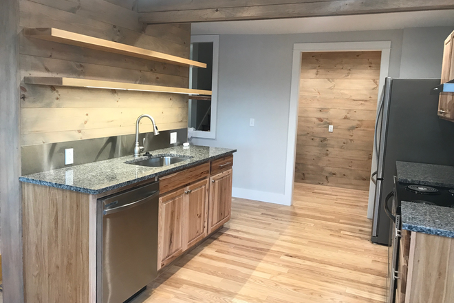 Kitchen w/ granite counters, shelving & adjacent large pantry - Completely Renovated 2 Floor, 3BR Apt in Downtown Burlington