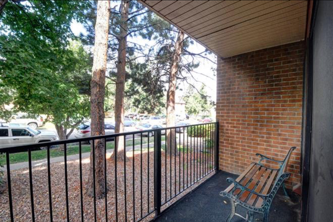Upstairs Balcony view. Showing view of street (flatirons to the left) - Four Star Realty Apartments