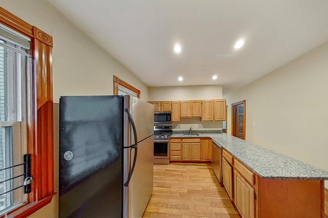 Updated kitchen with stainless steal appliances. Full size fridge/ freezer. Built-in microwave. Dishwasher. Stove and range. - Awesome 4 bed/ 1 bath in Mission Hill Triplex