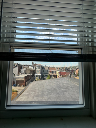View of bedroom window. - 1 BR Available in 2 BR Beautiful Rowhouse in Central Lawrenceville