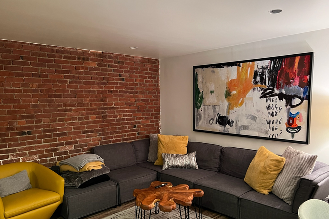 Living room. - Newly renovated and furnished apartment, 3min from Campus and Whole Foods, back patio access.