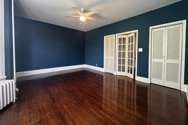 Bedroom, french doors lead to hallway - Charming Bolton Hill Apartment for Rent