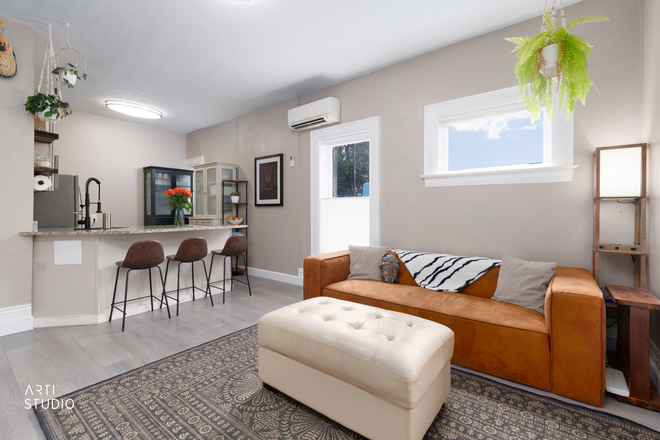 Open living, bar seating, and kitchen flow into one bright space for cooking, meals, and relaxing together. - Furnished 2BR/2BA, 6 Blocks to Campus, Both Ensuite, Utilities Included, Academic-Year Lease