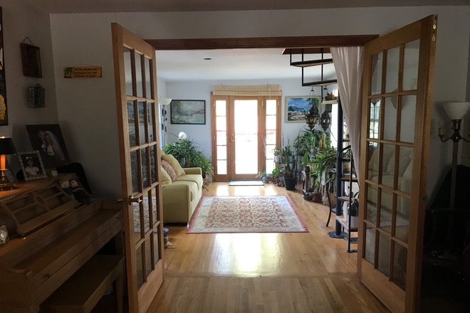 Living Room - Room in private home. Have own bathroom Furnished with full size bed. 2 mins to bus